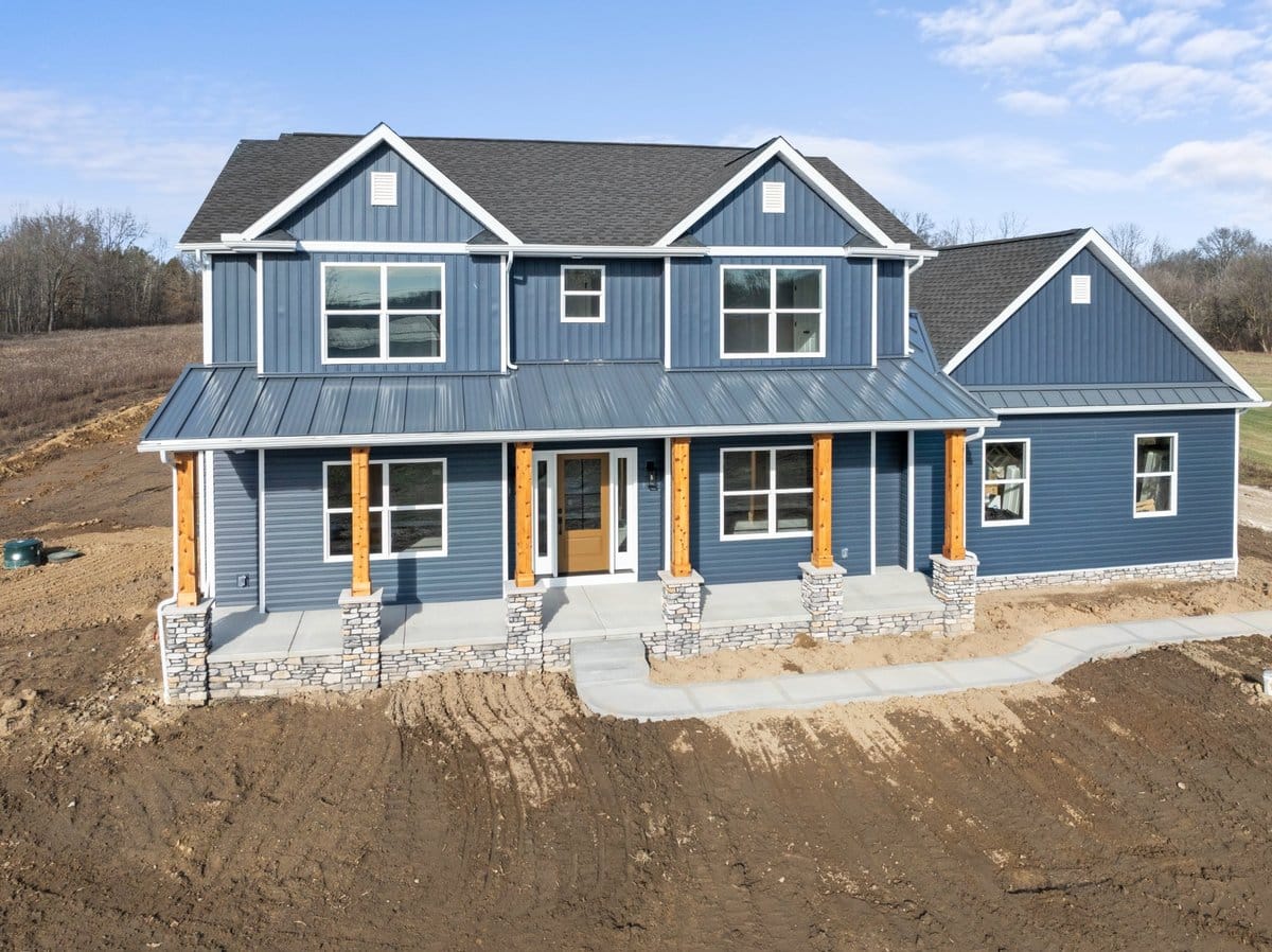 two-story-farmhouse-blue-siding-stone-porch-jackson-township-builder