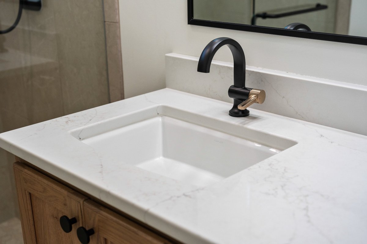 bathroom-vanity-black-champagne-hardware-quartz-top-lake-township-homes