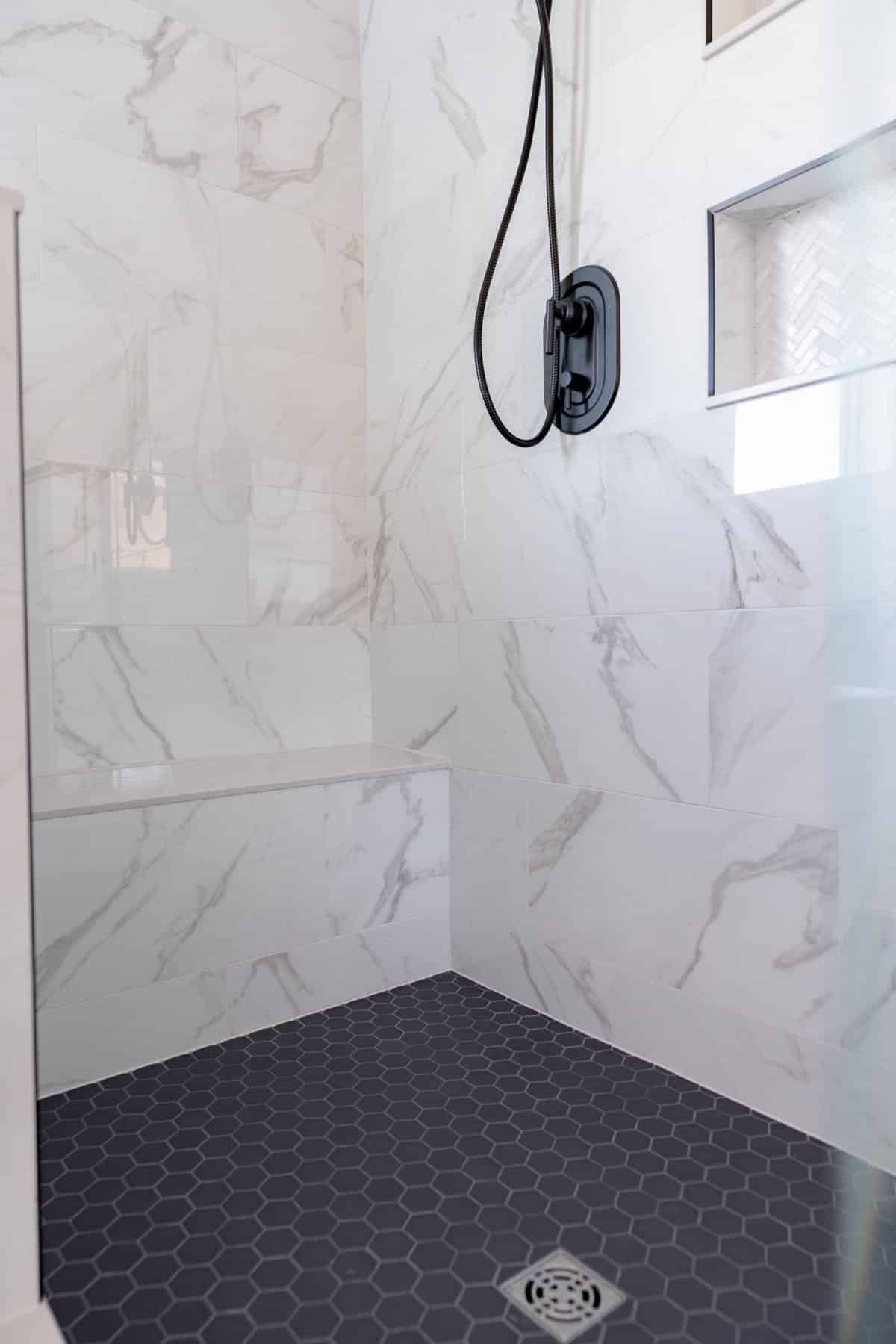 custom-shower-built-in-bench-marble-walls-tile-niche-summit-county