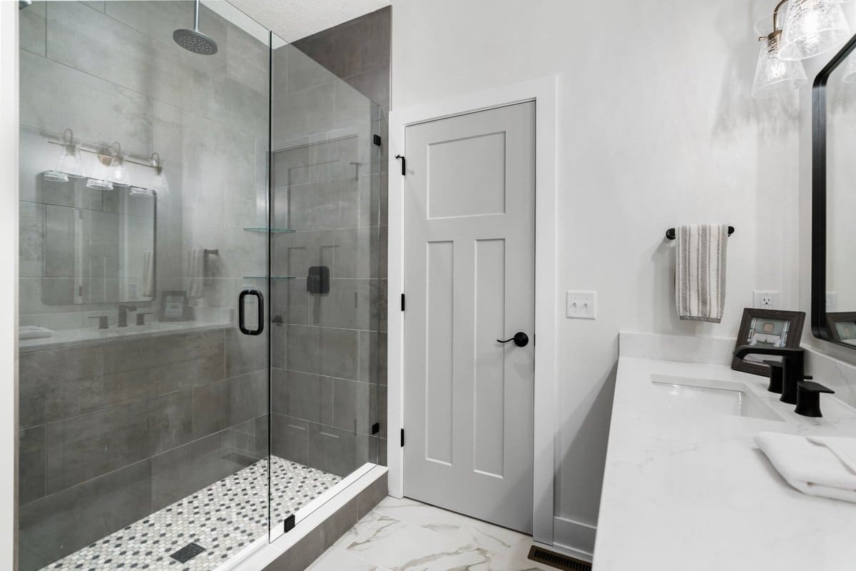 gray-tile-shower-pebble-floor-glass-enclosure-portage-county-homes