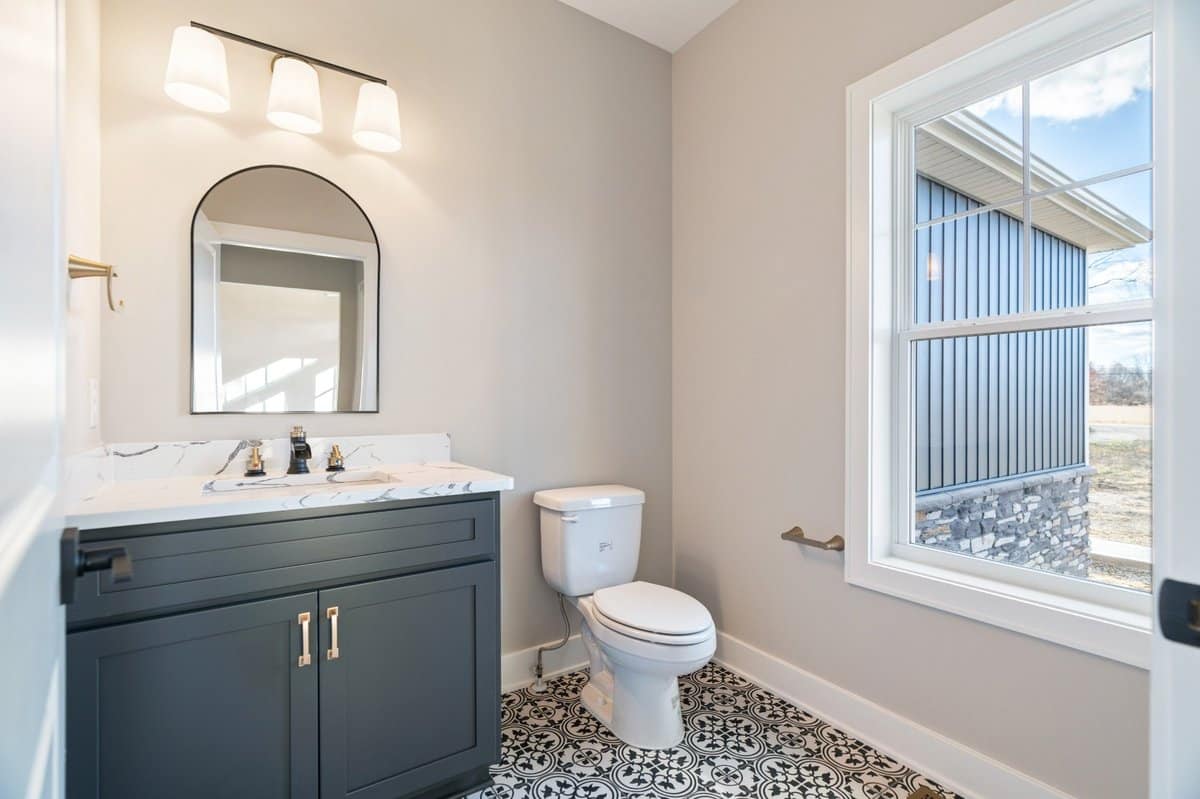 powder-room-patterned-tile-floor-navy-vanity-custom-home-portage-county