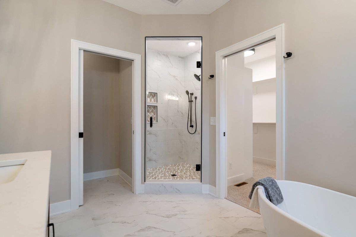 walk-in-shower-glass-enclosure-herringbone-tile-custom-homes-stark-county